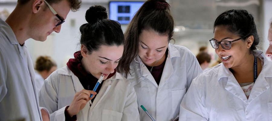 Group of scientists in white coats