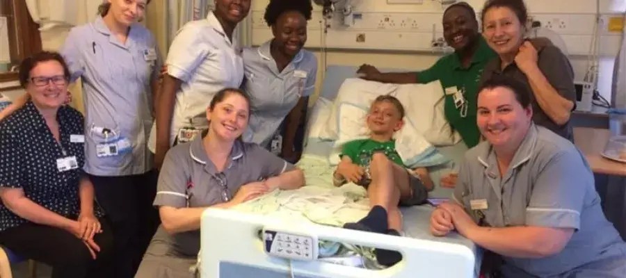 Mandy (far left) with son Matthew (centre) and support team