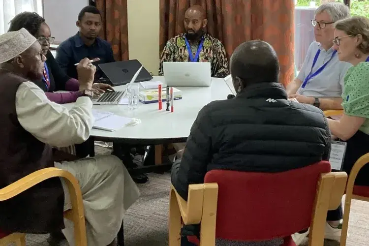 A group sits around a table talking